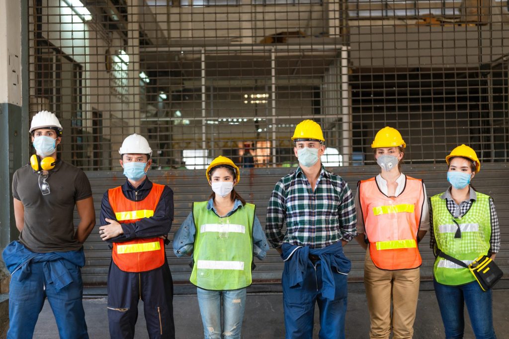 Group of industrial people standing at industrial factory